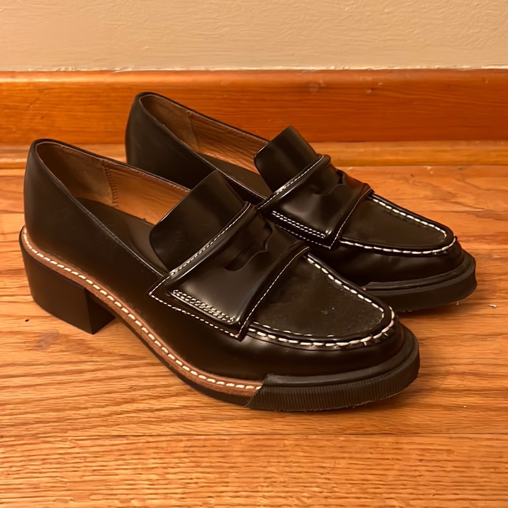 Barely worn black loafers with chunky heel and brown and white trim